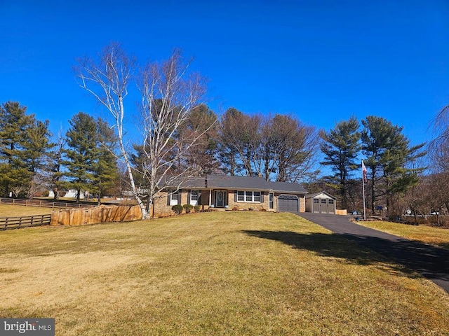 single story home featuring a garage, fence, and a front yard