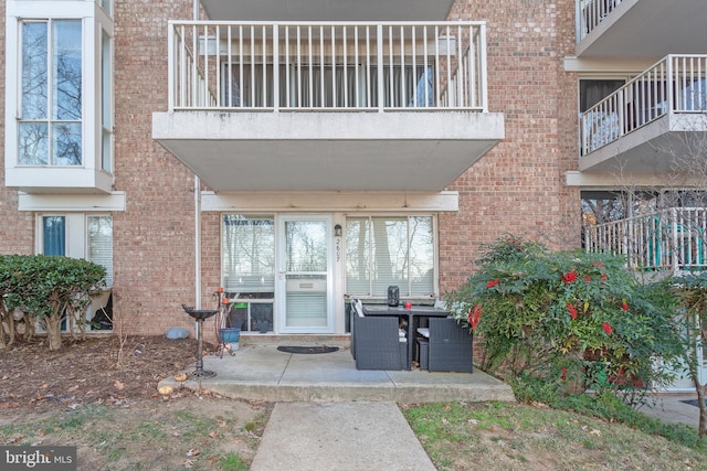 property entrance featuring brick siding