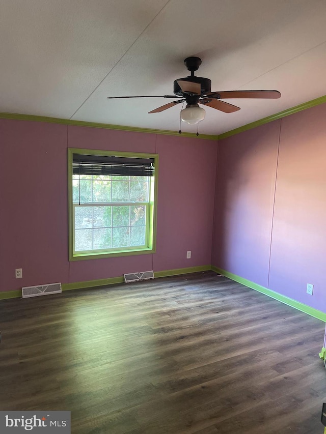 unfurnished room featuring ceiling fan, wood finished floors, visible vents, and baseboards