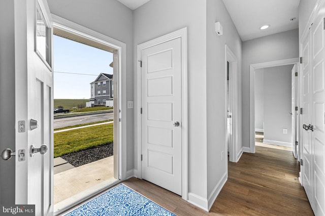 entryway with recessed lighting, wood finished floors, and baseboards