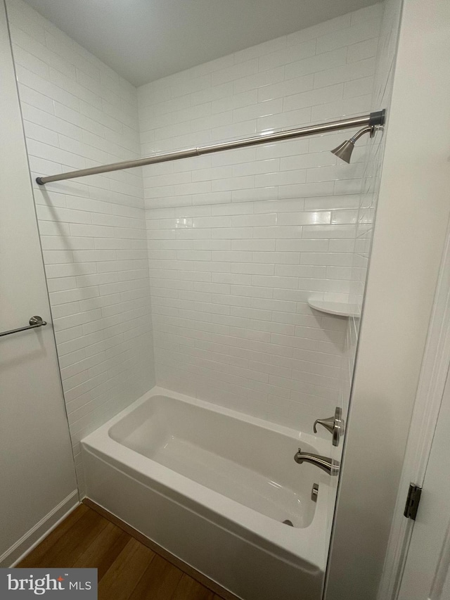 full bathroom with shower / bath combination and wood finished floors