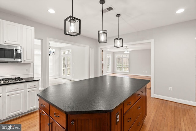 kitchen featuring dark countertops, light wood-style floors, visible vents, and appliances with stainless steel finishes