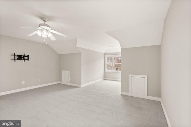 additional living space featuring baseboards, vaulted ceiling, and a ceiling fan