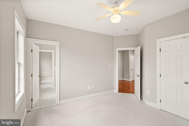 unfurnished bedroom featuring a ceiling fan, carpet flooring, and baseboards