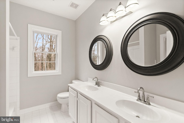 full bathroom featuring toilet, visible vents, a shower, and a sink