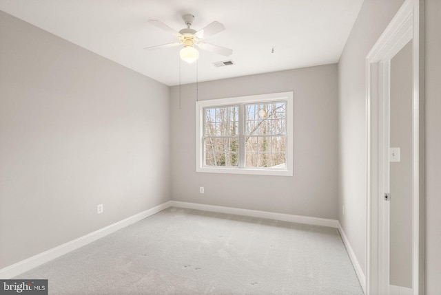 unfurnished bedroom featuring baseboards, visible vents, a ceiling fan, and light colored carpet