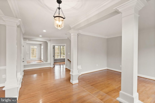 entryway with decorative columns, baseboards, light wood-style flooring, ornamental molding, and recessed lighting