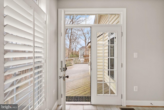 doorway to outside with visible vents, baseboards, and french doors