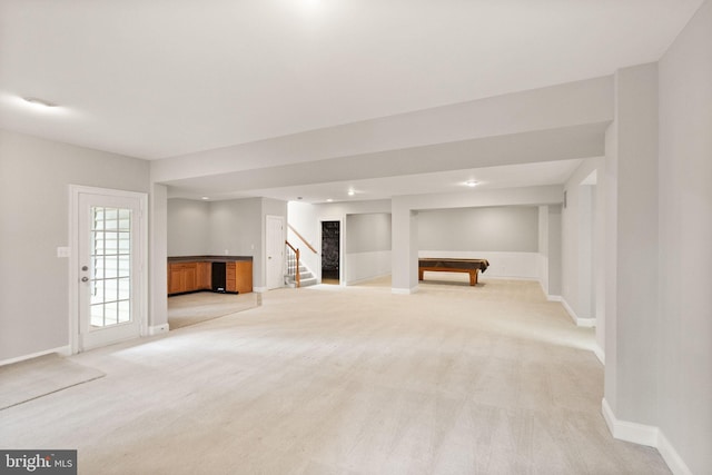 interior space with built in shelves, light colored carpet, pool table, baseboards, and stairs