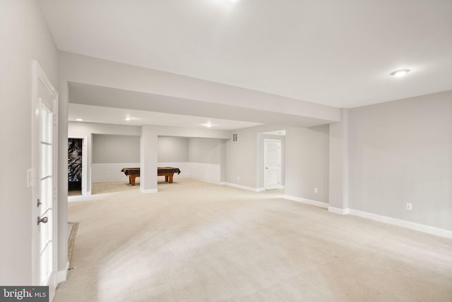 finished basement featuring billiards, baseboards, and light colored carpet