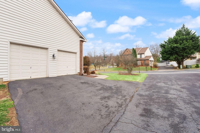 garage featuring aphalt driveway