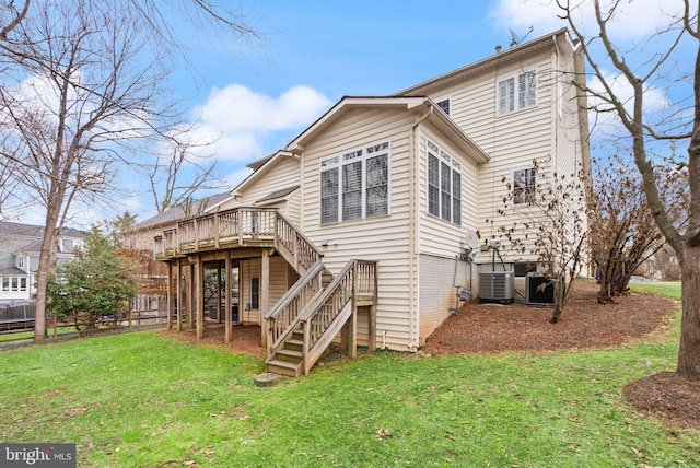 back of property with a wooden deck, stairs, cooling unit, and a yard