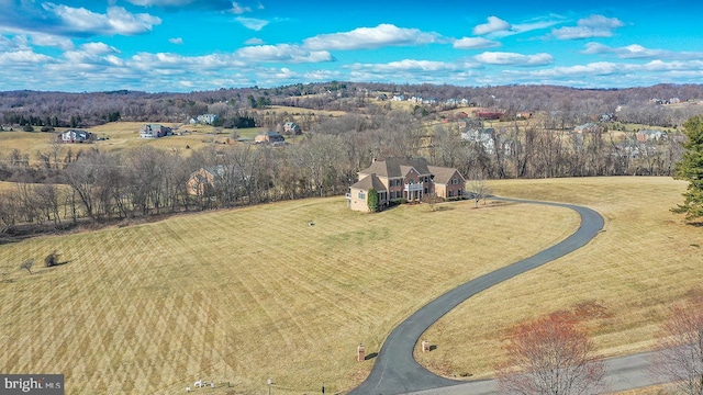 birds eye view of property featuring a rural view and a forest view