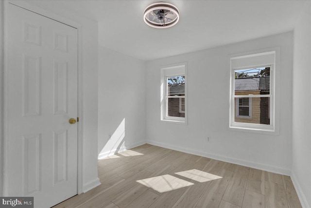 unfurnished bedroom featuring light wood finished floors and baseboards