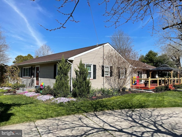 view of front of property with a front lawn and a gazebo