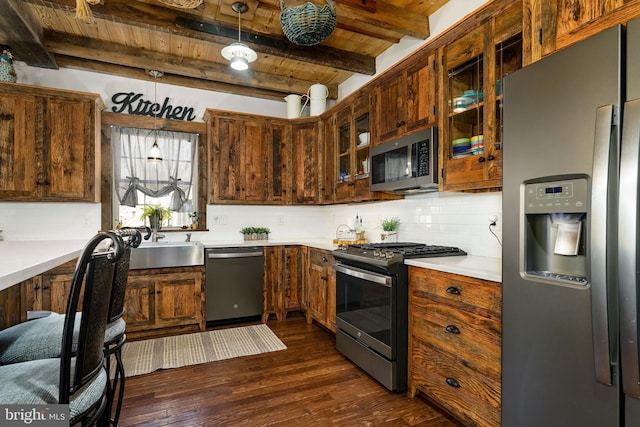 kitchen with wooden ceiling, stainless steel appliances, light countertops, backsplash, and dark wood finished floors