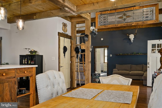 dining room featuring beamed ceiling, wood finished floors, and wood ceiling