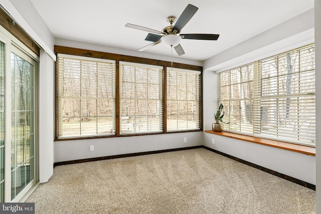 unfurnished sunroom featuring ceiling fan