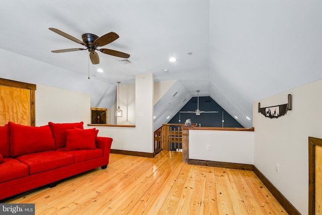 bonus room with vaulted ceiling, hardwood / wood-style floors, visible vents, and baseboards