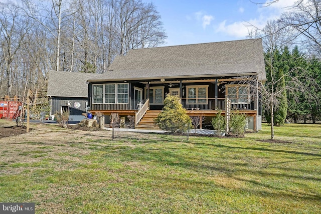 view of front of home featuring a shingled roof, a sunroom, stairs, a wooden deck, and a front yard