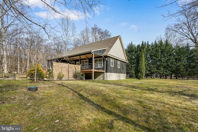 view of home's exterior with a shingled roof and a lawn