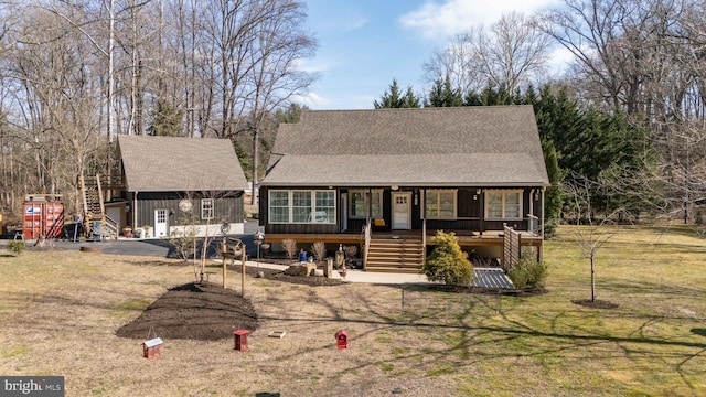 view of front of house with stairs, a porch, a front yard, and a shingled roof