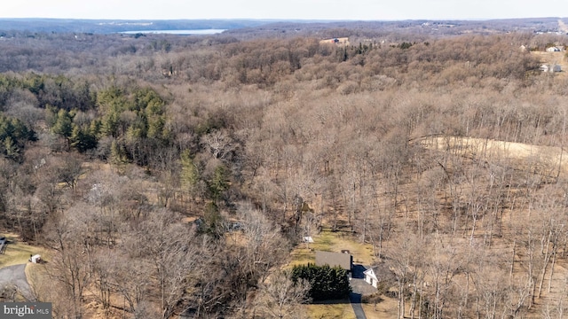 drone / aerial view featuring a forest view