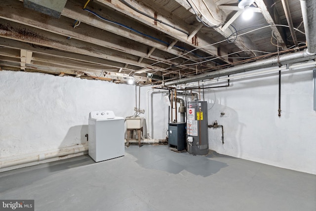 unfinished basement featuring water heater, washer / clothes dryer, and a sink