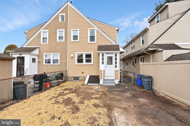 rear view of property with entry steps, a fenced backyard, and cooling unit