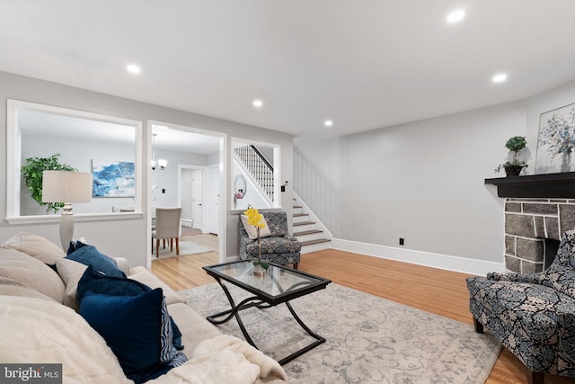 living room with stairway, wood finished floors, and recessed lighting