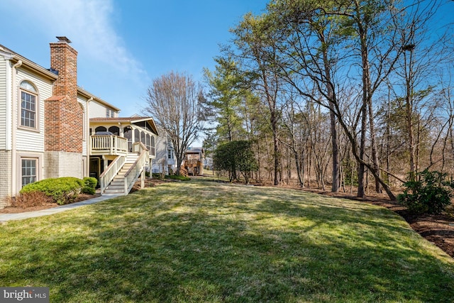 view of yard with stairs and a deck