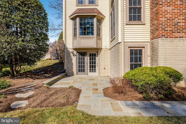 property entrance with french doors and brick siding