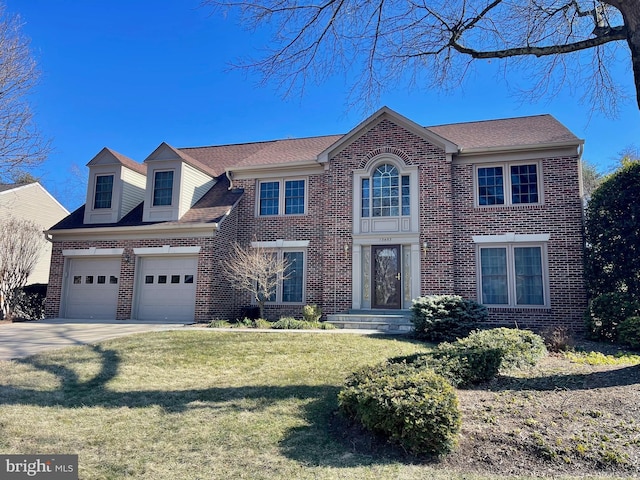 view of front of home with a garage, driveway, brick siding, and a front lawn