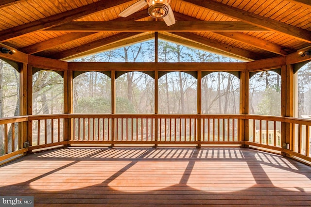 unfurnished sunroom featuring lofted ceiling with beams, ceiling fan, and wooden ceiling