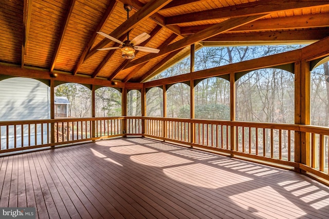 unfurnished sunroom featuring vaulted ceiling with beams and a ceiling fan