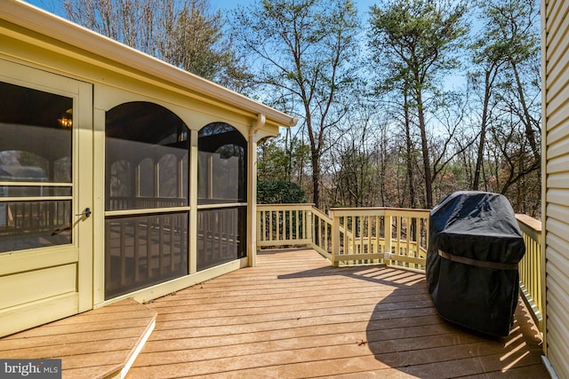 deck featuring a sunroom and grilling area