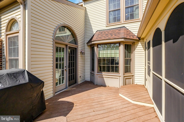 wooden terrace featuring a grill