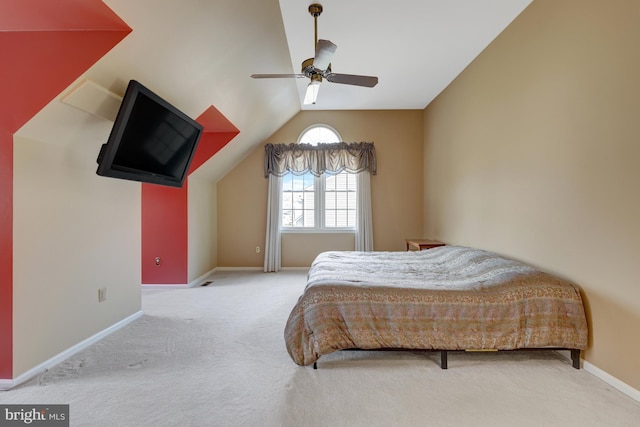 bedroom featuring carpet floors, vaulted ceiling, baseboards, and a ceiling fan