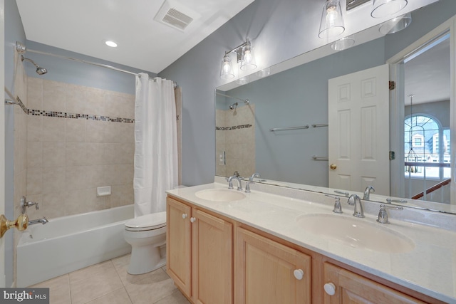 full bathroom featuring shower / bath combo, visible vents, a sink, and tile patterned floors