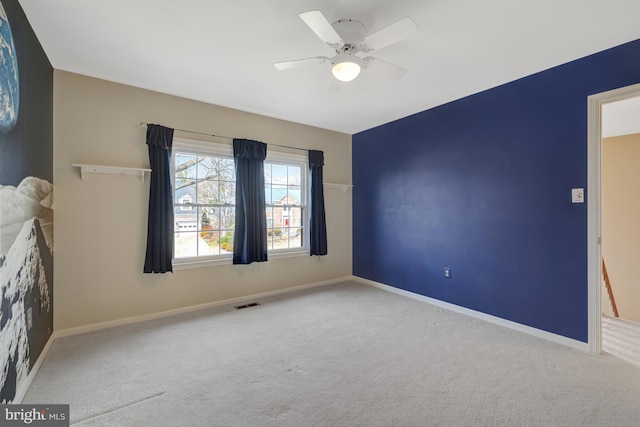 interior space with a ceiling fan, visible vents, and baseboards