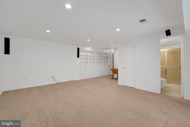 basement with baseboards, recessed lighting, visible vents, and light colored carpet