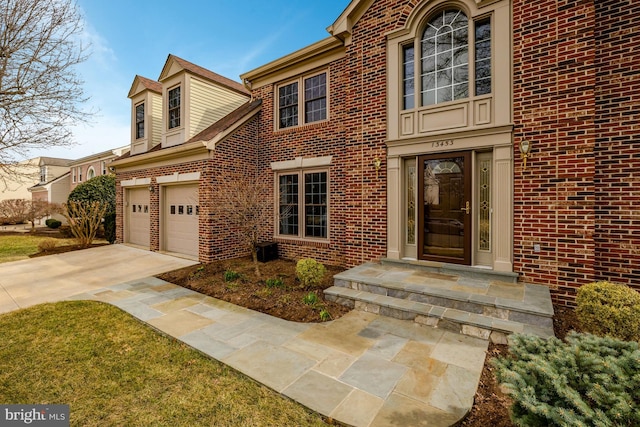 view of front facade featuring driveway and brick siding