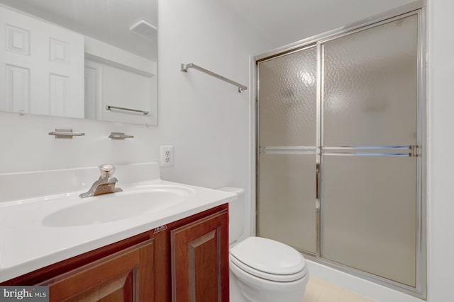 bathroom featuring visible vents, a shower stall, toilet, and vanity