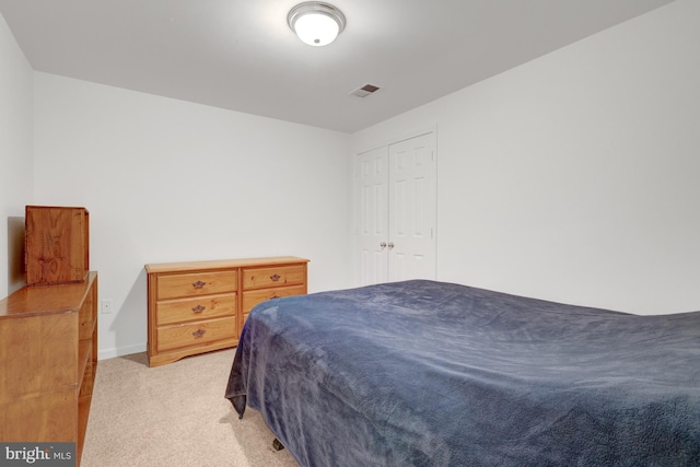 bedroom featuring visible vents and light colored carpet