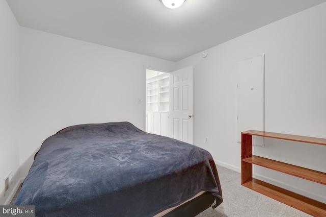 carpeted bedroom featuring baseboards