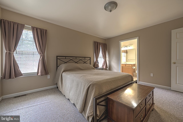 bedroom featuring carpet flooring, visible vents, baseboards, and multiple windows