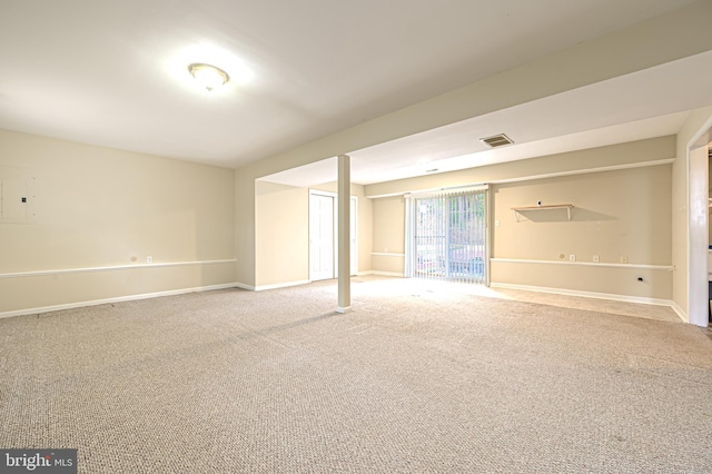 basement featuring carpet floors, visible vents, and baseboards