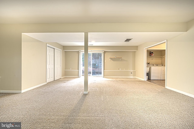 interior space with carpet floors, visible vents, baseboards, and separate washer and dryer