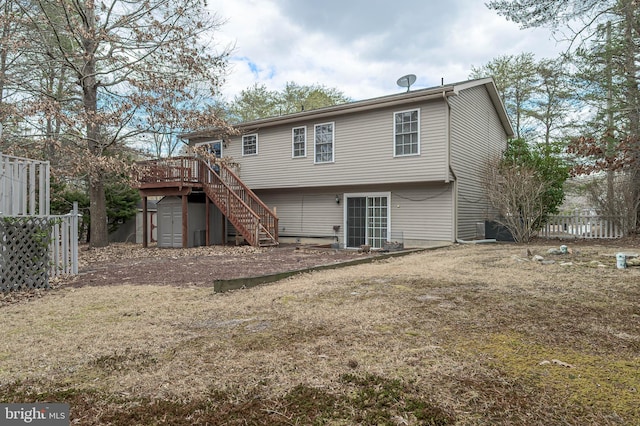 rear view of house with stairs, fence, a deck, and an outdoor structure