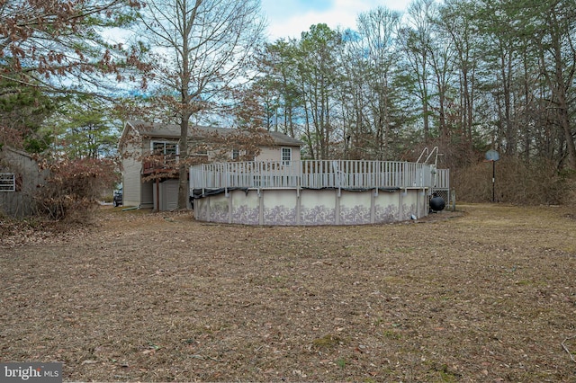 back of house with a covered pool